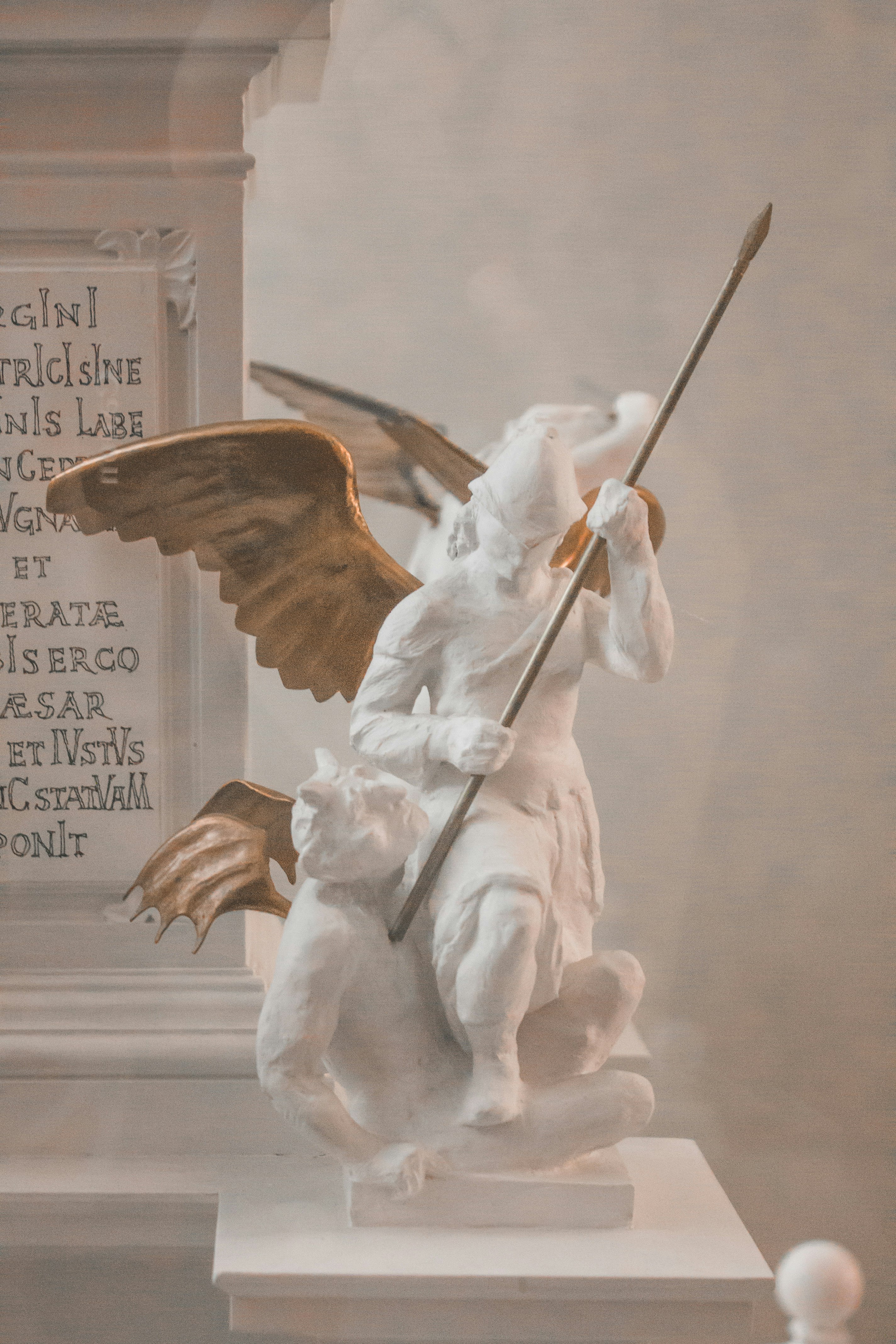 angel holding stick statue with quote